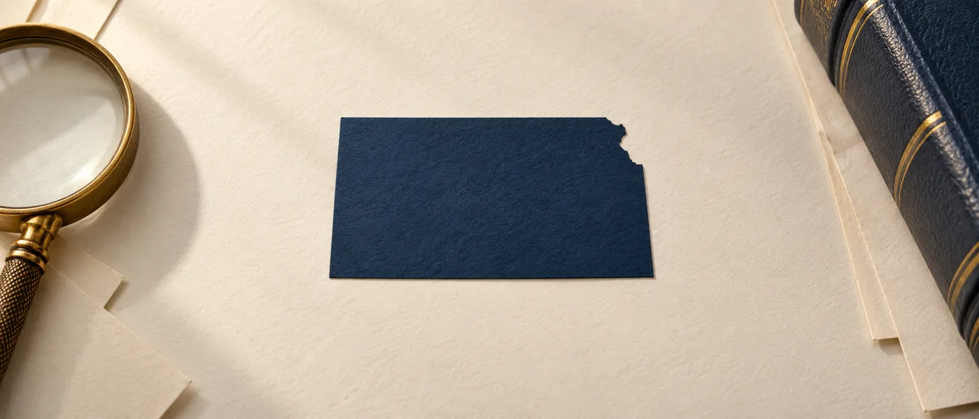Editorial illustration of the Kansas state outline on legal documents beside a magnifying glass.