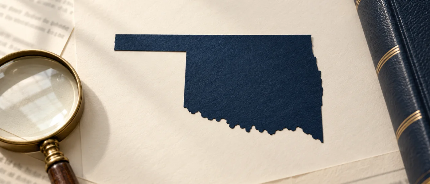 Editorial illustration of the Oklahoma state outline on legal documents beside a magnifying glass.